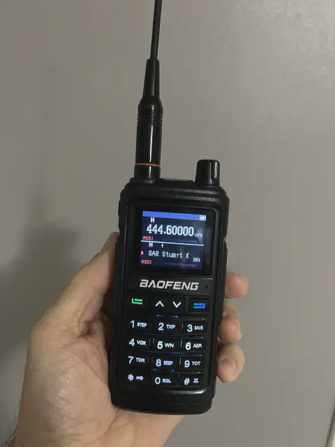 baofeng btech uv 17r plus front view with black antenna attached black textured body single control knob lcd display control buttons numeric keypad