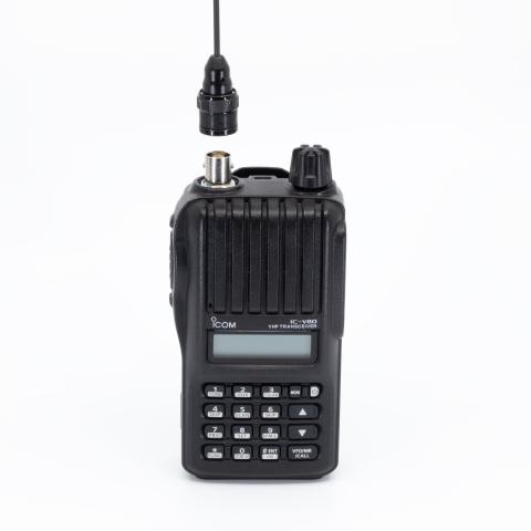 icom ic v80 front view showing bnc connector without antenna black ribbed body single control knob lcd display numeric keypad function keys