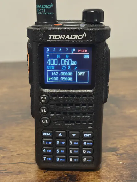 tidradio td h8 front view with black antenna attached black textured body single control knob lcd display speaker grille numeric keypad