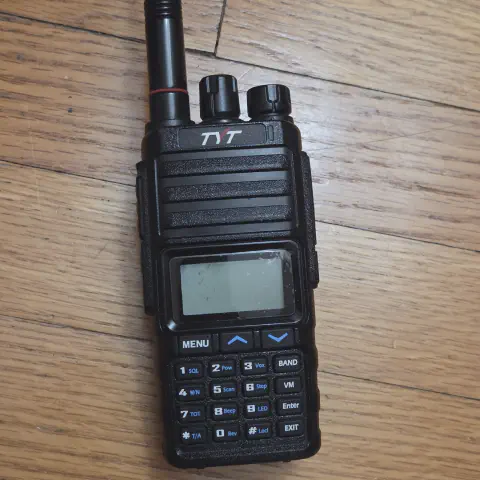 tyt th 350 front view with black antenna attached ribbed body two control knobs lcd display numeric keypad function keys