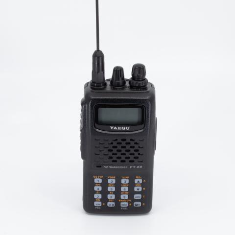 yaesu ft 60 front view with black antenna attached using 3d printed spacer black textured body two control knobs lcd display numeric keypad function keys speaker grille